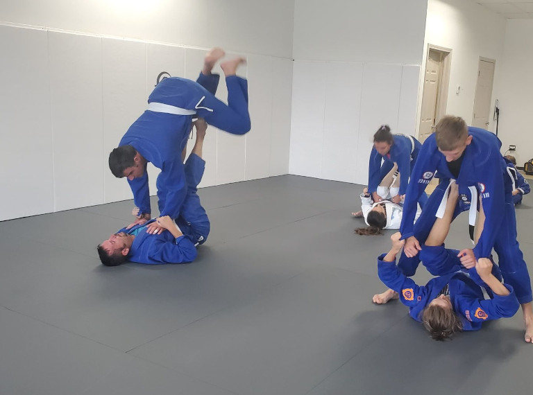 adults drilling jiujitsu sweeps